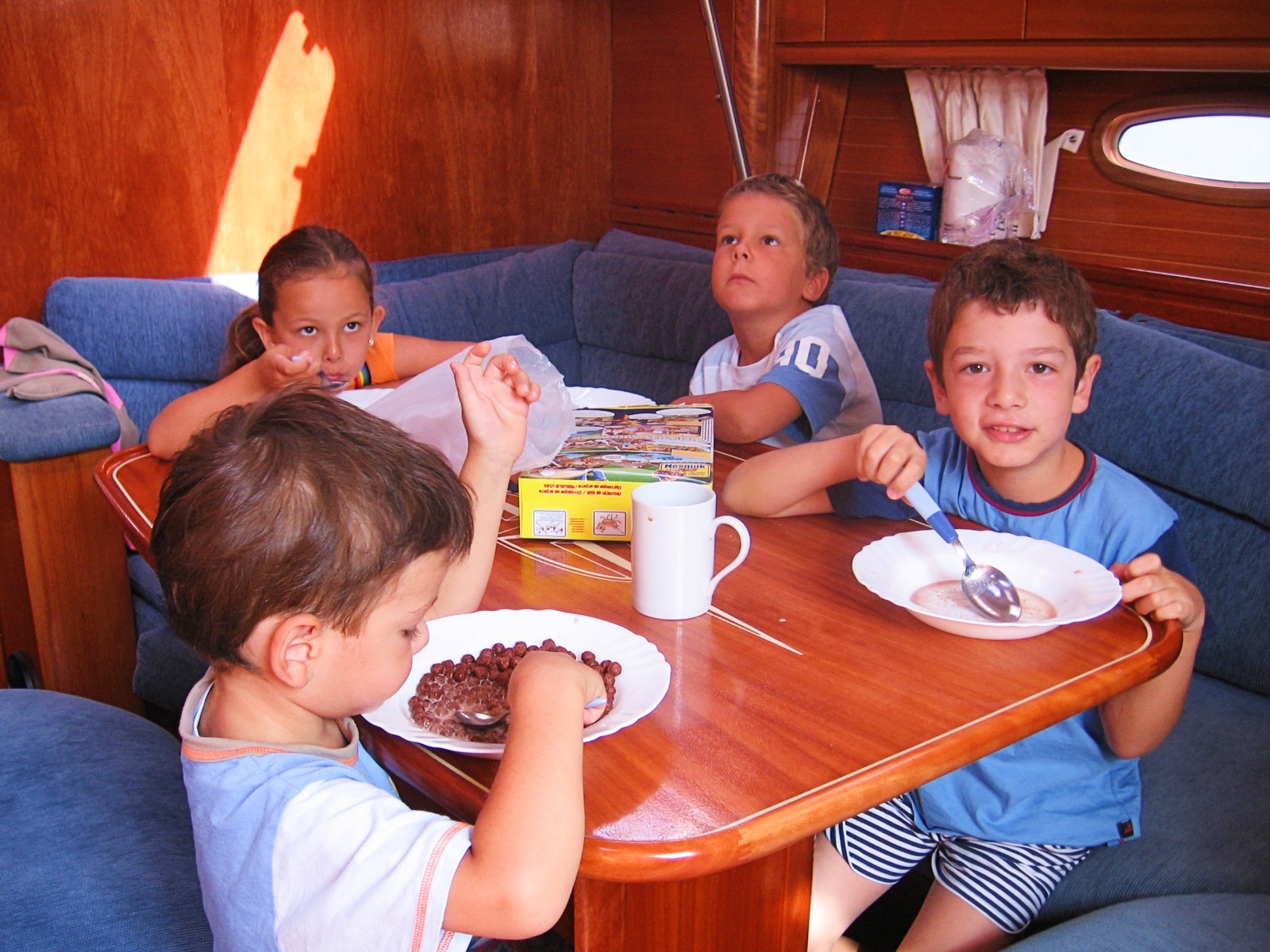 Kids having a snack on a sailboat