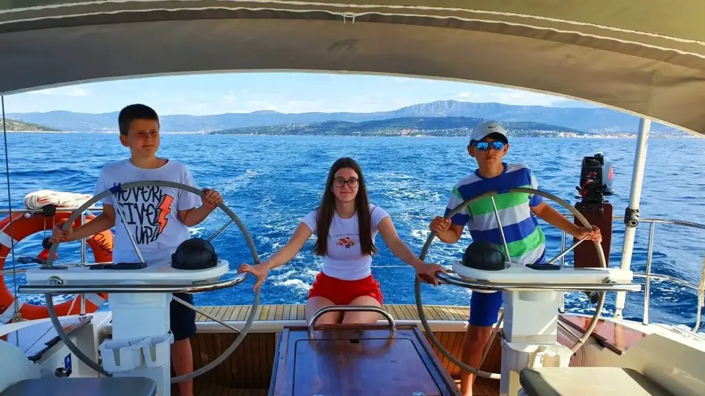 Kids having fun while steering a boat