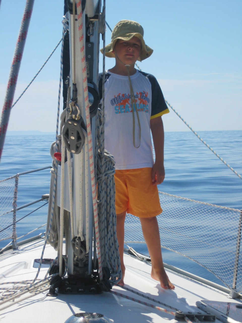 Sun protection on a sailboat kid wearing a hat